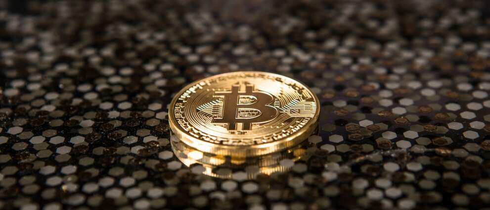 gold-colored Bitcoin coin on ground
